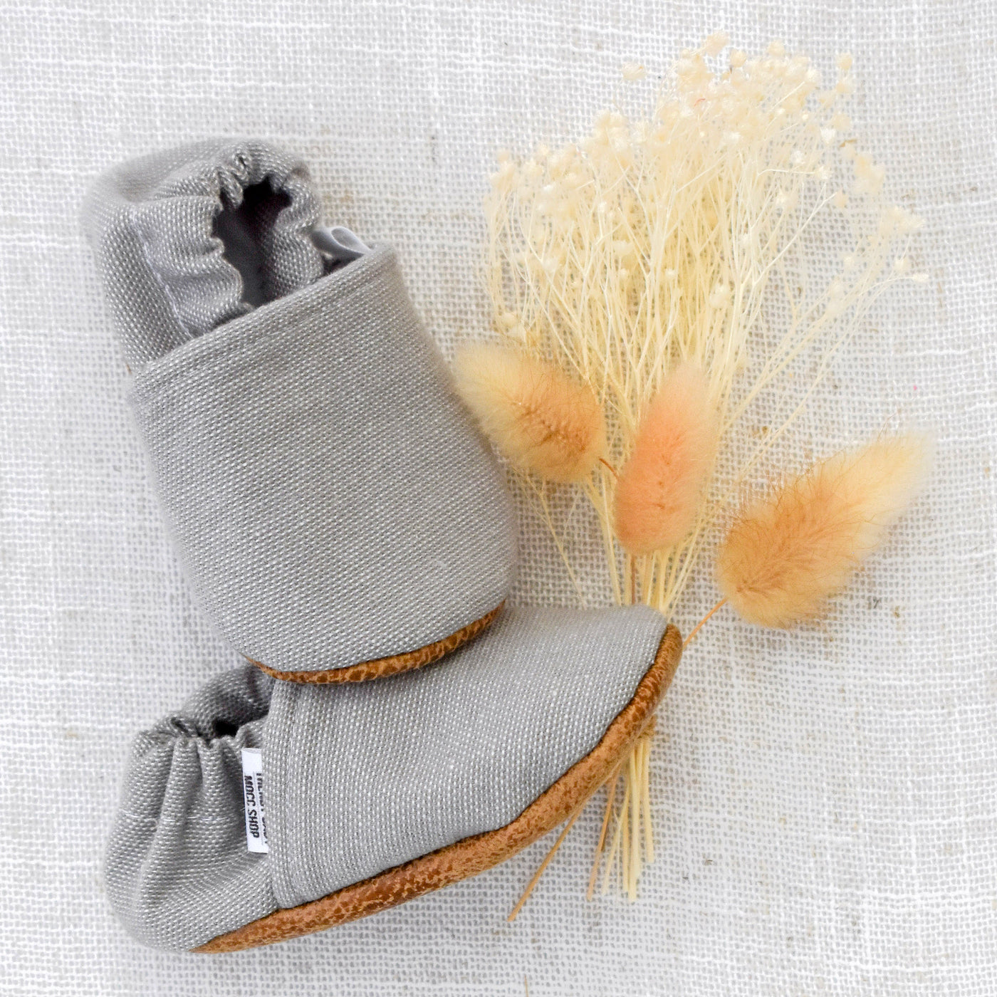 Baby and me gift box. Close up of Light Grey Textured Moccasins