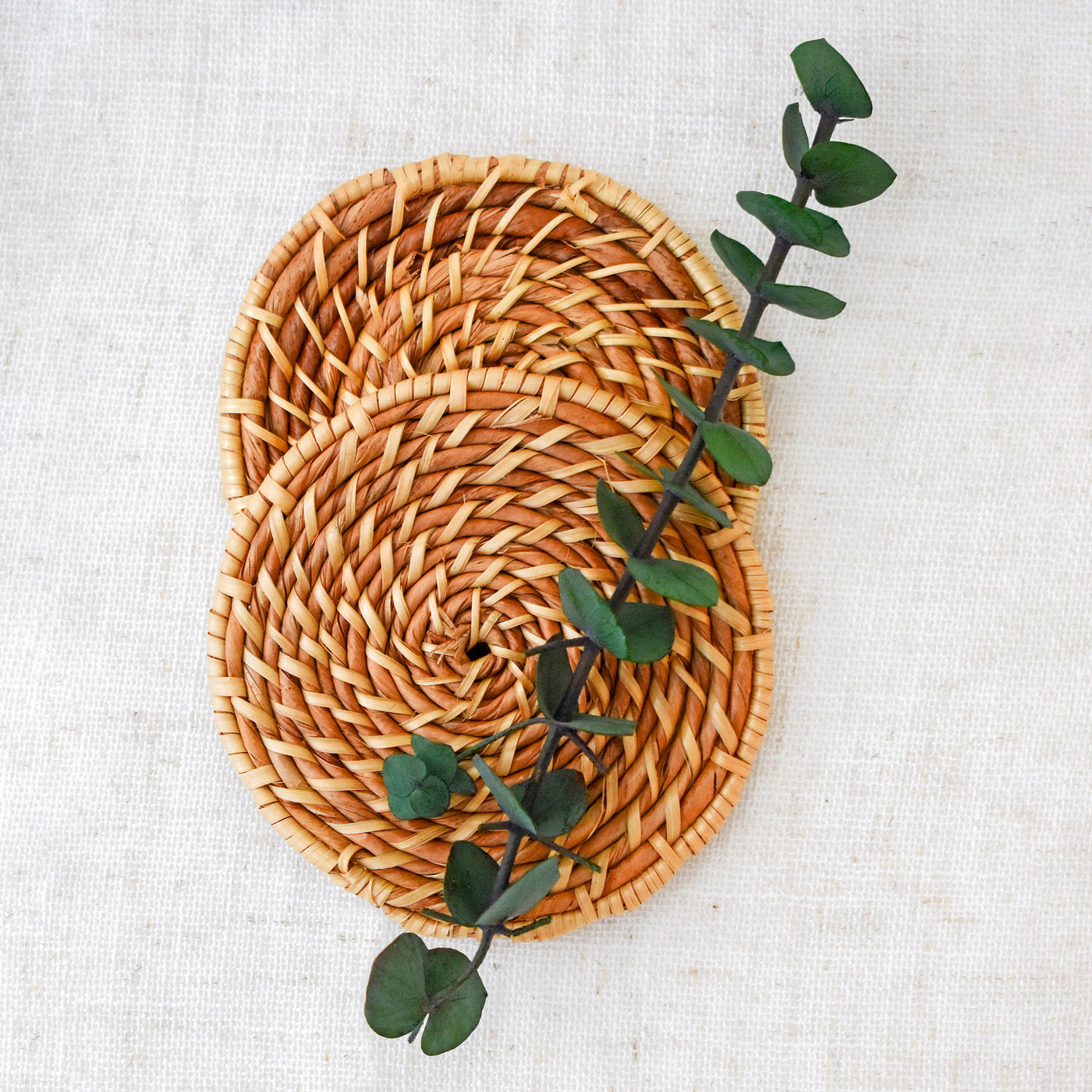 Help new home dwellers settle in with this beautifully refreshing gift box. Close up of Rattan Coasters