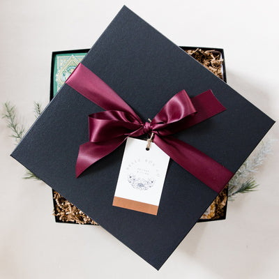 A clever and playful gift to help foster connection at home. This gift box includes all the makings of an amazing game night! This is the top of the gift box.