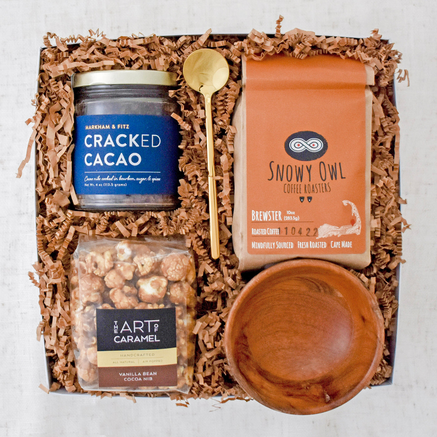 Encourage the break from reality to enjoy some sweet treats and a cup of joe. This gift basket includes: Cracked Cacao, Brewster Coffee, Vanilla Bean Cocoa Nib Popcorn, Wooden Pinch Bowl, Gold Stirring Spoon