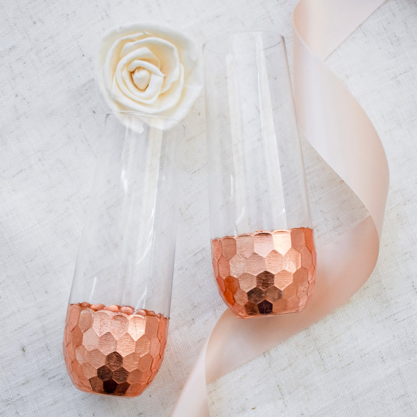 Spread the love with this decadent and romantic gift box. Perfect for weddings, anniversaries or just because! Close up of Hammered Copper Stemless Champagne Glasses