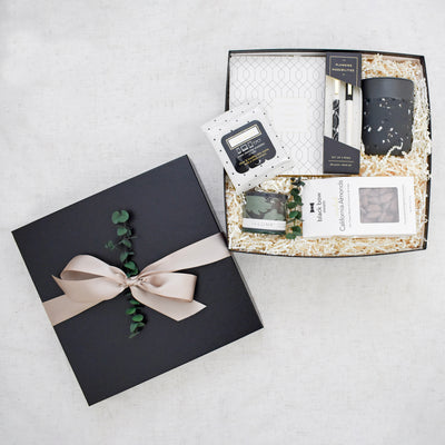 Celebrate the professional milestones and encourage perseverance for all things that lie ahead. This large 2 pc black gift box contains: Daily Planner Pad, Pen Set, Ceramic Mug, Screen Cleansing Towelettes, Blackberry Absinthe Candle, and California Candied Almonds.